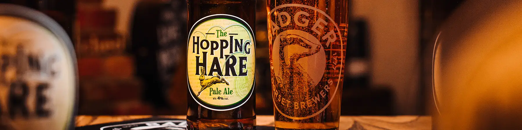bottle and pint of badgers hopping hare on table