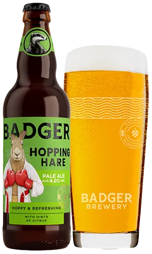 bottle and glass filled with badgers hopping hare pale ale on plain background