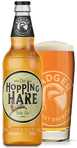 bottle and glass filled with badgers hopping hare pale ale on plain background