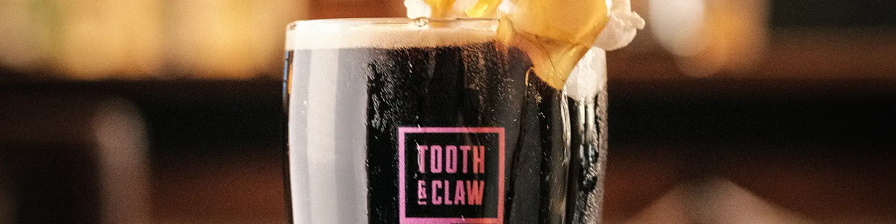 pint of tooth & claw beer being poured