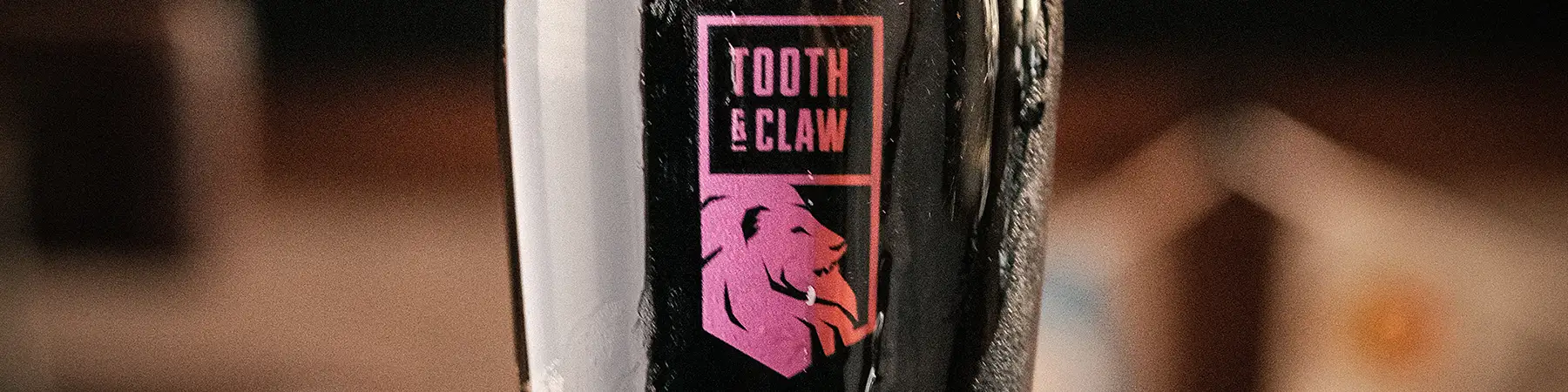 close up of tooth & claw logo on tap
