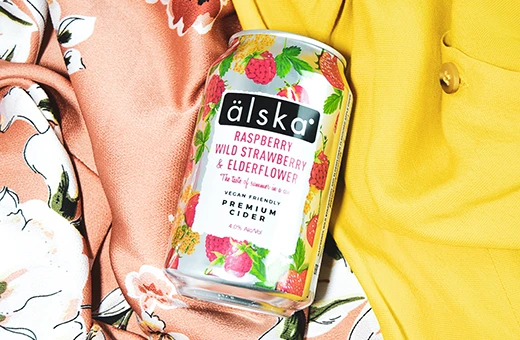 can of alska raspberry, wild strawberry & elderflower cider on different silk fabrics