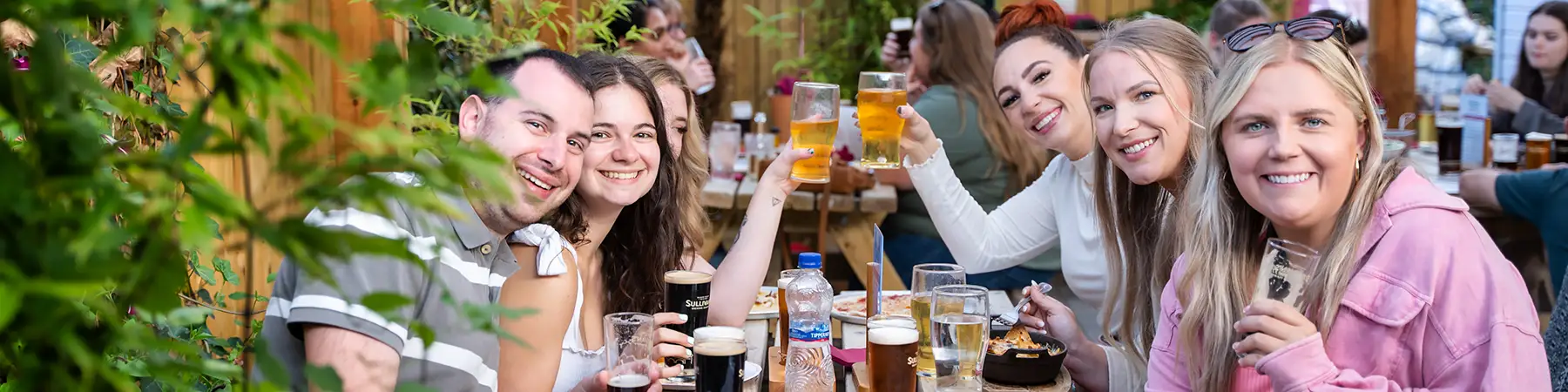 people drinking pints of sullivans beers on beer garden