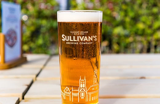 pint of Sullivans on table in the sunshine