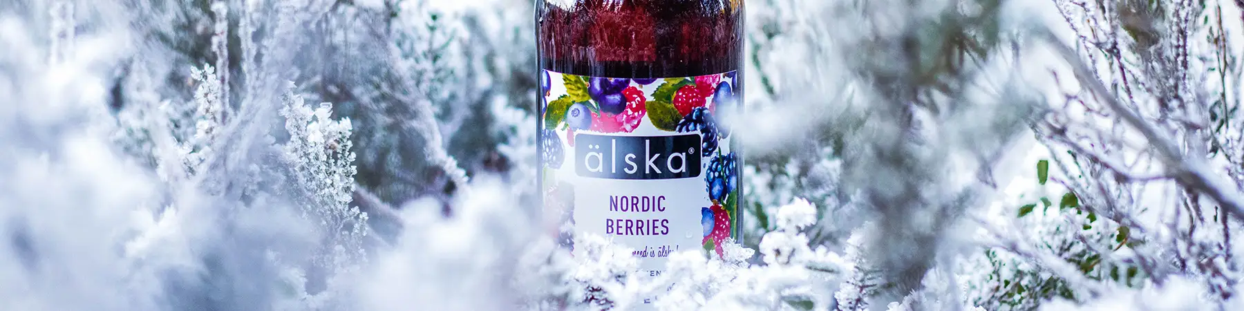 bottle of alska nordic berries outdoors in snow covered trees
