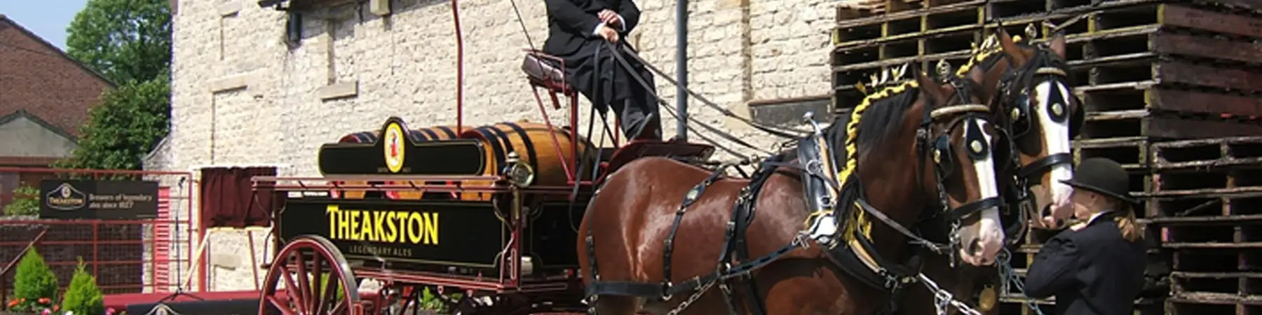 horse drawn carriage with Theakston brewery logo on side