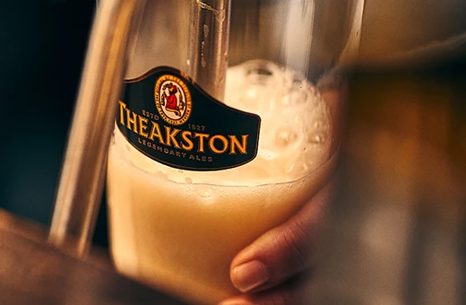 pint of Theakston being poured from tap