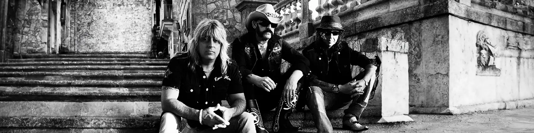 Motörhead road crew sat on steps