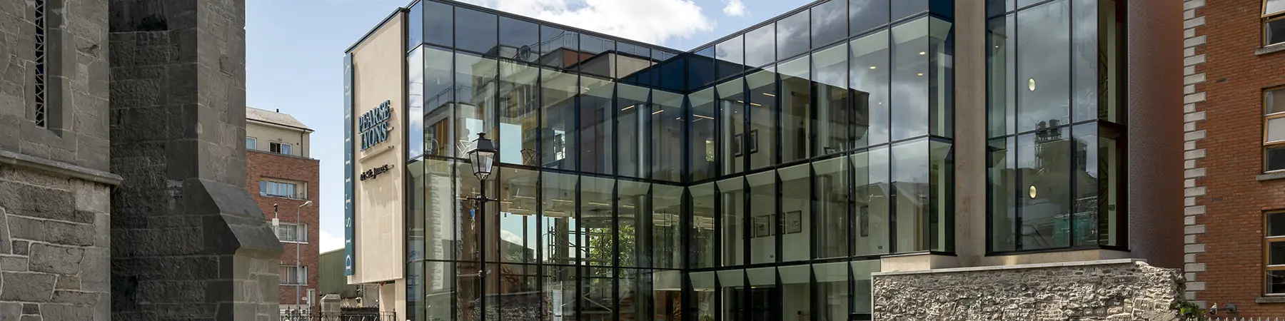 glass outdoor wall of Pearse Lyons distillery visitor centre